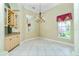 Formal dining room area with chandelier, large mirror and custom cabinetry at 126 Peckham Sw St, Port Charlotte, FL 33952