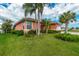 Single-story house with an attached garage and mature landscaping at 126 Peckham Sw St, Port Charlotte, FL 33952