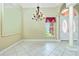 Open foyer with decorative chandelier, high ceilings, pillars, and white tile floors at 126 Peckham Sw St, Port Charlotte, FL 33952