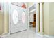 Elegant front entrance with white double doors featuring decorative glass and soaring ceilings at 126 Peckham Sw St, Port Charlotte, FL 33952