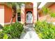 Charming home entrance with double doors, decorative glass, and lush landscaping at 126 Peckham Sw St, Port Charlotte, FL 33952