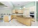 Modern kitchen with an island, granite countertops, and stylish lighting fixtures at 126 Peckham Sw St, Port Charlotte, FL 33952