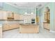 Well-lit kitchen with an island, wooden cabinets, and modern appliances at 126 Peckham Sw St, Port Charlotte, FL 33952