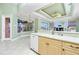 Bright kitchen with a breakfast bar and a view of the screened patio at 126 Peckham Sw St, Port Charlotte, FL 33952
