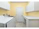 Bright laundry room featuring cabinetry, countertop space, and appliances at 126 Peckham Sw St, Port Charlotte, FL 33952