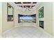Living room area with tile flooring and water views, plus a ceiling fan and small fireplace at 126 Peckham Sw St, Port Charlotte, FL 33952