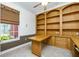 Dedicated office space featuring built-in shelves, drawers, and a functional desk with a window view at 126 Peckham Sw St, Port Charlotte, FL 33952