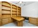 Spacious home office with custom built-in shelving, drawers, and wrap-around desk space at 126 Peckham Sw St, Port Charlotte, FL 33952