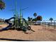 Community playground featuring climbing structures, slides and swings located next to a sandy beach at 126 Peckham Sw St, Port Charlotte, FL 33952