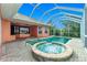 Backyard boasts a sparkling pool and spa, perfect for relaxation and entertaining at 126 Peckham Sw St, Port Charlotte, FL 33952