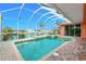 Backyard featuring screened-in pool and spa overlooking a waterfront canal at 126 Peckham Sw St, Port Charlotte, FL 33952