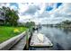 Charming waterfront dock with boat access, surrounded by lush landscaping and serene canal views at 126 Peckham Sw St, Port Charlotte, FL 33952