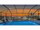 Stunning waterfront view from the screened-in pool, perfect for relaxation and entertaining at sunset at 3307 Dominica Ct, Punta Gorda, FL 33950