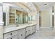 Spacious bathroom boasts double sinks, a large mirror, and vanity at 126 Peckham Sw St, Port Charlotte, FL 33952