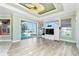 Bright living room featuring an entertainment center, access to the pool, and picturesque waterfront views at 126 Peckham Sw St, Port Charlotte, FL 33952