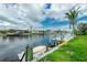 Picturesque waterfront view with private dock, kayak, and tropical landscaping at 126 Peckham Sw St, Port Charlotte, FL 33952