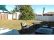 Expansive backyard with lush lawn, privacy fence, shed, and outdoor seating area for relaxation and entertaining at 3380 Maple Ter, Port Charlotte, FL 33952