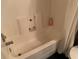 Standard white bathtub with shower head and a bottle of lotion on the shower ledge at 3380 Maple Ter, Port Charlotte, FL 33952