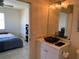 Bathroom boasts vessel sink, decorative lighting, and is accessible from the adjacent bedroom at 3380 Maple Ter, Port Charlotte, FL 33952