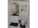 Bathroom with modern toilet, vanity with vessel sink, decorative mirror and light fixtures at 3380 Maple Ter, Port Charlotte, FL 33952