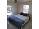 Bright bedroom with neutral walls and tile floor featuring a ceiling fan and natural light at 3380 Maple Ter, Port Charlotte, FL 33952
