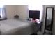 Bedroom with windows, television, and decorative mirror at 3380 Maple Ter, Port Charlotte, FL 33952
