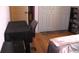 Cozy bedroom with hardwood floors, closet, and shelves for storage and decor at 3380 Maple Ter, Port Charlotte, FL 33952