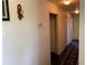 Hallway with carpet runner leading to bedrooms, bathrooms, or closets at 3380 Maple Ter, Port Charlotte, FL 33952
