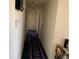 Hallway with patterned runner rug and a series of doors at 3380 Maple Ter, Port Charlotte, FL 33952