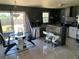 Modern kitchen featuring stainless steel appliances, a stylish island with seating, and sliding door access to the backyard at 3380 Maple Ter, Port Charlotte, FL 33952