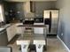 Well-lit kitchen with stainless steel appliances, granite countertops, and island with stools at 3380 Maple Ter, Port Charlotte, FL 33952