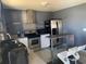 Clean kitchen featuring stainless steel appliances, white cabinets, and a gray central island with seating at 3380 Maple Ter, Port Charlotte, FL 33952