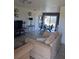 Comfortable living room features neutral tones, tile flooring, and access to the outdoor area at 3380 Maple Ter, Port Charlotte, FL 33952