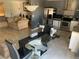 Open-concept living area with combined kitchen, glass dining table, and comfortable seating at 3380 Maple Ter, Port Charlotte, FL 33952