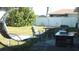 Well-maintained backyard with a cozy swing, outdoor seating, and a lush lawn, creating a perfect space for relaxation at 3380 Maple Ter, Port Charlotte, FL 33952