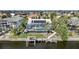 Aerial view of a private home featuring a pool, lush landscaping, and a private dock at 5028 San Massimo Dr, Punta Gorda, FL 33950