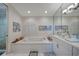 Bright bathroom featuring a soaking tub under an arched shuttered window and a vanity sink at 5028 San Massimo Dr, Punta Gorda, FL 33950