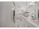 Bright bathroom featuring an extra-long vanity, modern lighting and a large mirror at 5028 San Massimo Dr, Punta Gorda, FL 33950