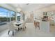 Bright dining area with a chandelier, dining table, and a view of the pool at 5028 San Massimo Dr, Punta Gorda, FL 33950