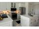 Modern kitchen featuring white cabinetry, stainless steel appliances, and a center island at 5028 San Massimo Dr, Punta Gorda, FL 33950