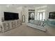 Comfortable living room featuring a large television, stylish furniture, and a well-lit entry at 5028 San Massimo Dr, Punta Gorda, FL 33950