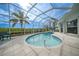 Enclosed pool deck with view of palm trees and mangrove waterway at 5028 San Massimo Dr, Punta Gorda, FL 33950