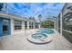 Inviting screened-in pool area with a spa, tiled deck, and comfortable lounge seating at 5028 San Massimo Dr, Punta Gorda, FL 33950