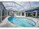 Enclosed pool with water feature overlooks an inviting outdoor space with a table and chairs at 5028 San Massimo Dr, Punta Gorda, FL 33950