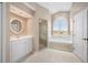 Well-lit bathroom showcasing tile floors, white cabinets, a bathtub, and a glass door shower at 7352 Parkinsonia, Punta Gorda, FL 33955