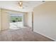 Bedroom with neutral carpet, natural light, and sliding doors to the screened patio at 1426 Natrona Dr, North Port, FL 34286