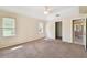 Spacious carpeted bedroom with a ceiling fan, closet, and natural light, great for a relaxing retreat at 1426 Natrona Dr, North Port, FL 34286