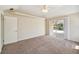 Carpeted bedroom with a sliding glass door that leads to the lanai, and lots of natural light at 1426 Natrona Dr, North Port, FL 34286