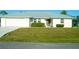 Charming single-story home with a well-manicured lawn and a two car garage at 1426 Natrona Dr, North Port, FL 34286