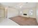 Open living room featuring a fireplace, tile and carpet flooring, and abundant natural light at 1426 Natrona Dr, North Port, FL 34286